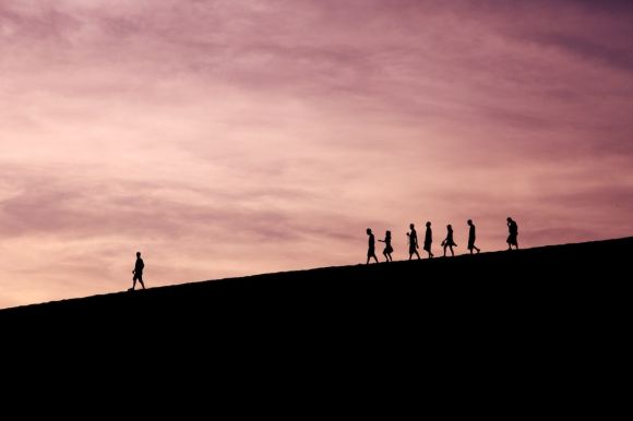 Leader - silhouette of people on hill